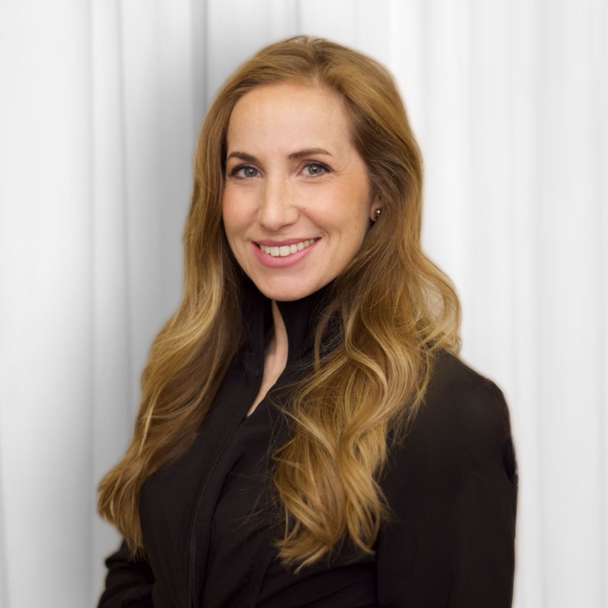 Dr. Mollie Lindquist, DDS, smiling in a studio portrait
