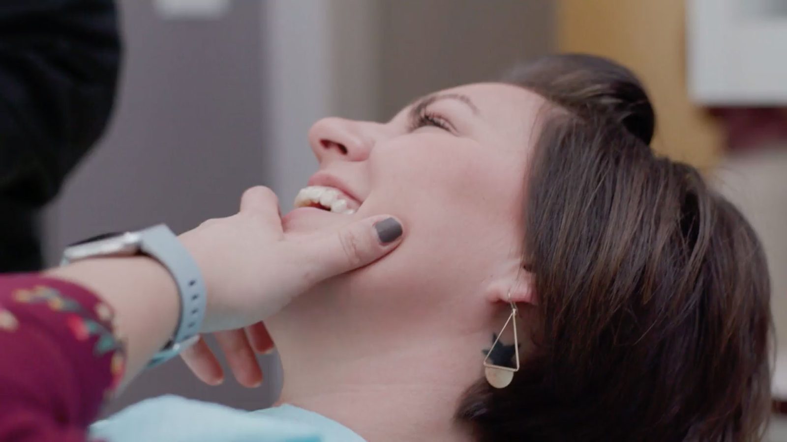 A Diamond Ridge Dentistry provider examining a patient's smile